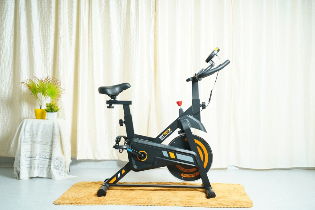 Exercise bike on mat with fan for home workout