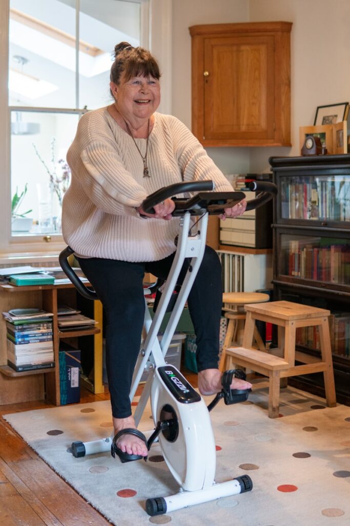 Person using upright exercise bike at home