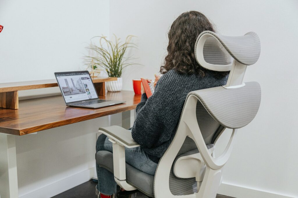 Office worker using smart posture corrector wearable for daily comfort